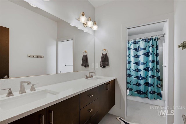 bathroom featuring a sink, shower / bathtub combination with curtain, and double vanity