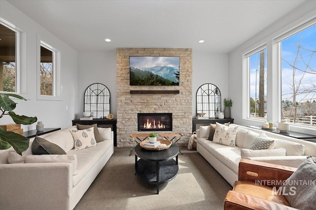 carpeted living room featuring recessed lighting and a fireplace