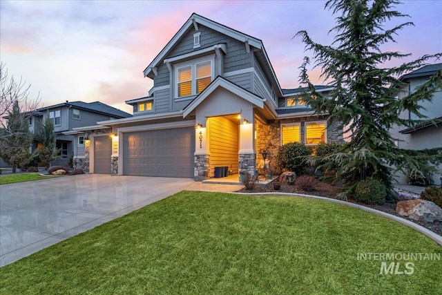 view of front of property with a garage, a front yard, stone siding, and driveway