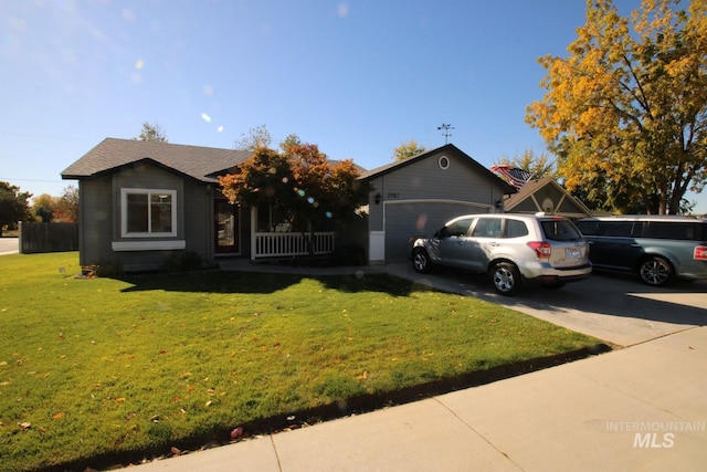 ranch-style home with a garage and a front lawn