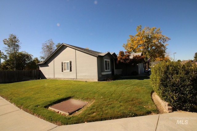 view of side of home with a lawn