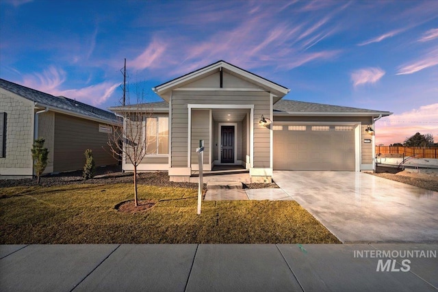 view of front of property with a garage and a lawn