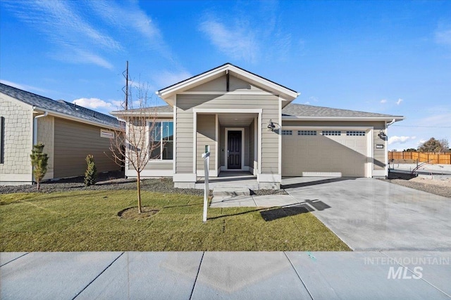 ranch-style house with a garage and a front lawn