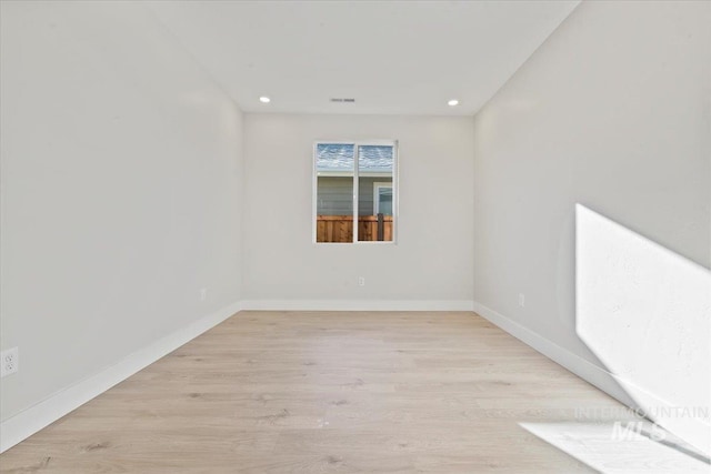 spare room with light hardwood / wood-style flooring