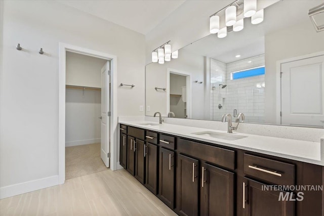 bathroom featuring an enclosed shower and vanity