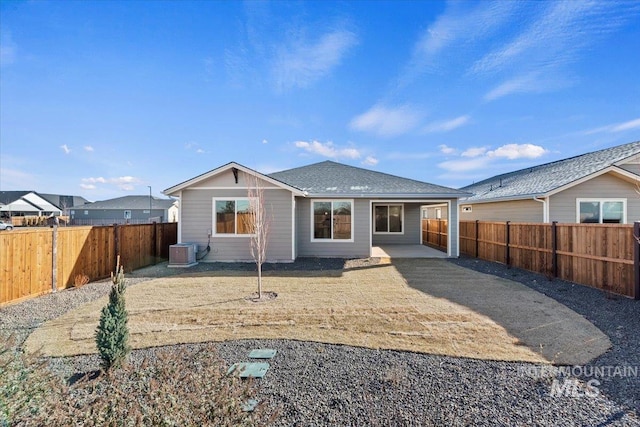 rear view of property featuring cooling unit and a patio area