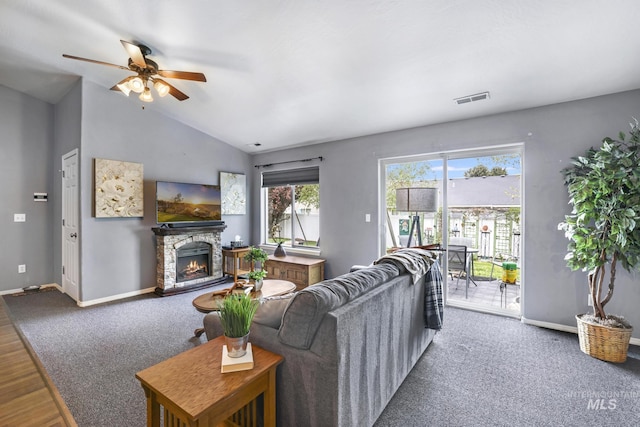 1517 Elm St N, Jerome, ID 83338 - living room featuring a ceiling fan, baseboards, vaulted ceiling, a fireplace, and carpet