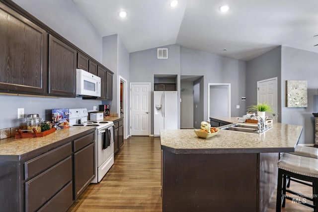 1517 Elm St N, Jerome, ID 83338 - kitchen with white appliances, a sink, dark brown cabinetry, wood finished floors, and light countertops