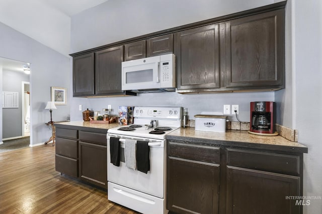 1517 Elm St N, Jerome, ID 83338 - kitchen with white appliances, dark brown cabinetry, dark wood-style floors, baseboards, and lofted ceiling