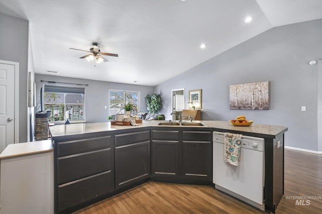 1517 Elm St N, Jerome, ID 83338 - kitchen with white dishwasher, a sink, vaulted ceiling, ceiling fan, and wood finished floors