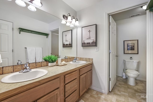 1517 Elm St N, Jerome, ID 83338 - bathroom with toilet, double vanity, and baseboards