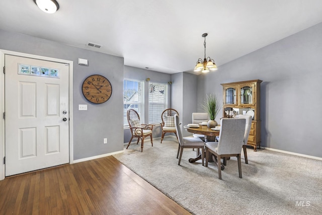 1517 Elm St N, Jerome, ID 83338 - dining room featuring a chandelier, baseboards, and wood finished floors