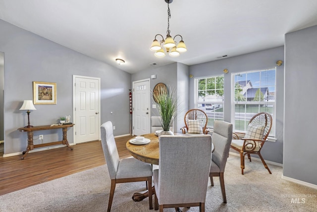 1517 Elm St N, Jerome, ID 83338 - dining space with a chandelier, baseboards, light carpet, and vaulted ceiling