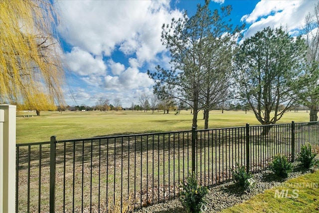 view of yard featuring a rural view and fence