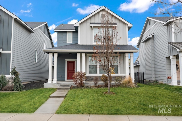 1873 W American Fork Dr, Meridian, ID 83642 - view of front of home with covered porch, board and batten siding, a front yard, and a shingled roof