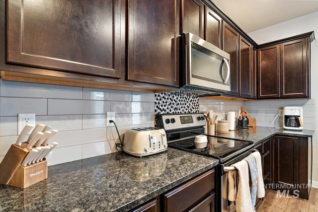 1873 W American Fork Dr, Meridian, ID 83642 - kitchen featuring appliances with stainless steel finishes, dark brown cabinetry, decorative backsplash, and dark stone countertops
