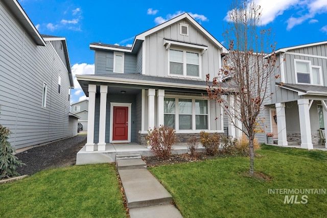 1873 W American Fork Dr, Meridian, ID 83642 - view of front of home with board and batten siding, a porch, a front yard, and stone siding