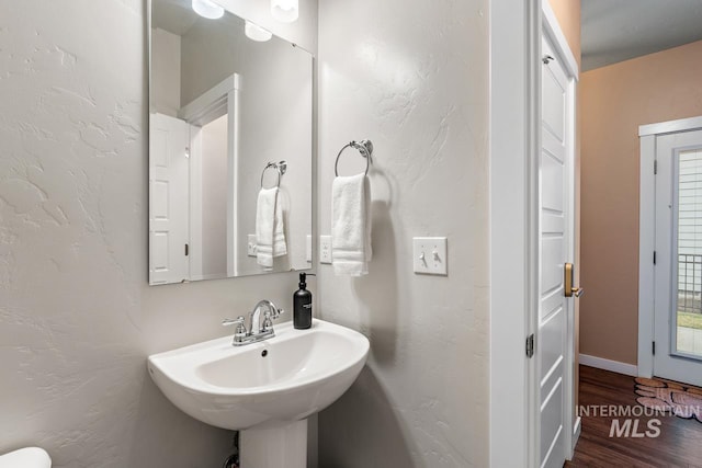 1873 W American Fork Dr, Meridian, ID 83642 - half bathroom featuring wood finished floors, a textured wall, and a sink