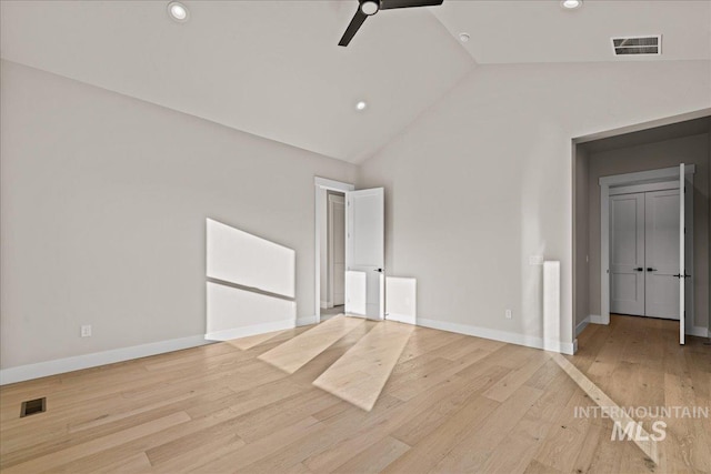 unfurnished bedroom with high vaulted ceiling, ceiling fan, and light wood-type flooring