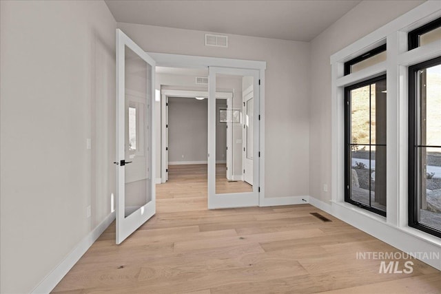 interior space featuring light wood-type flooring and french doors