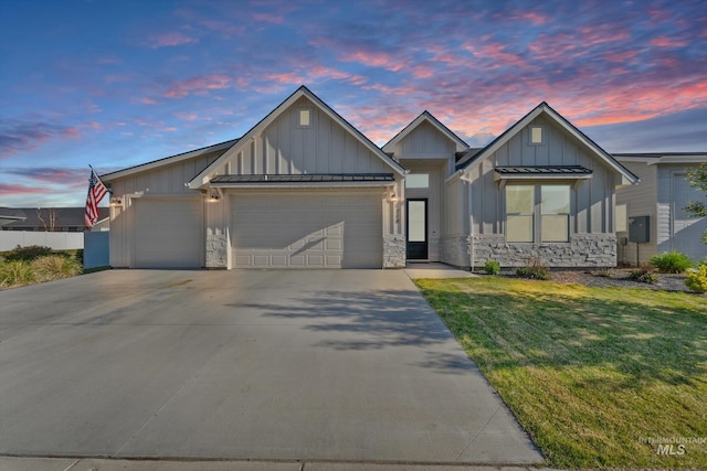 view of front of house with stone siding, a garage, and board and batten siding