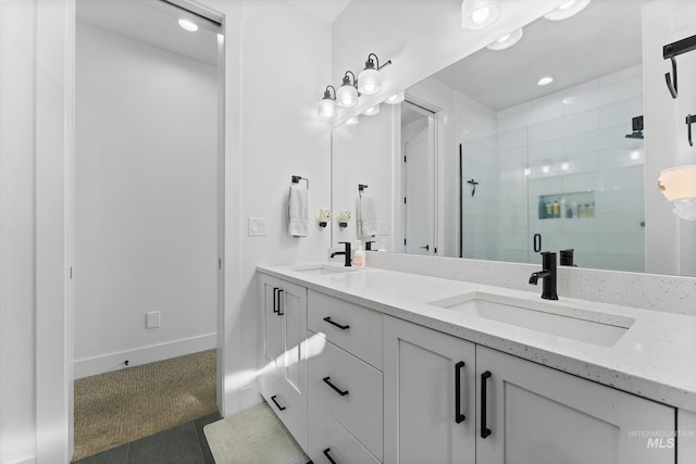 full bath with a shower stall, a sink, double vanity, and recessed lighting