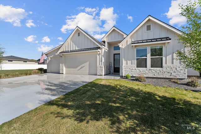 view of front facade with concrete driveway, board and batten siding, an attached garage, a front yard, and a standing seam roof