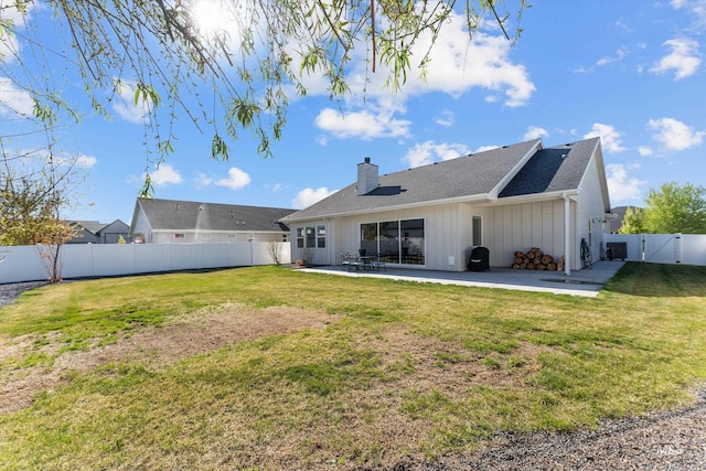 rear view of property featuring board and batten siding, a chimney, a patio area, a gate, and a fenced backyard