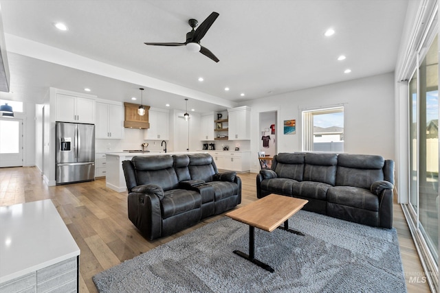 living area featuring recessed lighting, light wood-style flooring, and ceiling fan