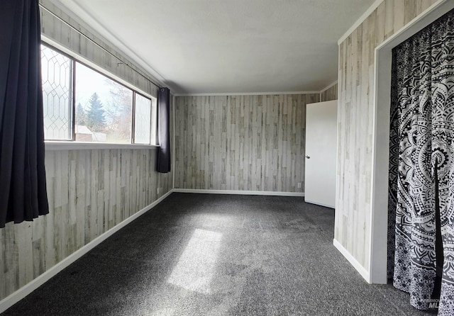 522 Ellis Ave, Winchester, ID 83555 - empty room featuring baseboards, wooden walls, and ornamental molding