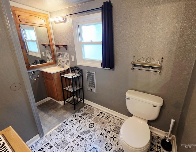 522 Ellis Ave, Winchester, ID 83555 - half bathroom featuring plenty of natural light, toilet, vanity, and baseboards