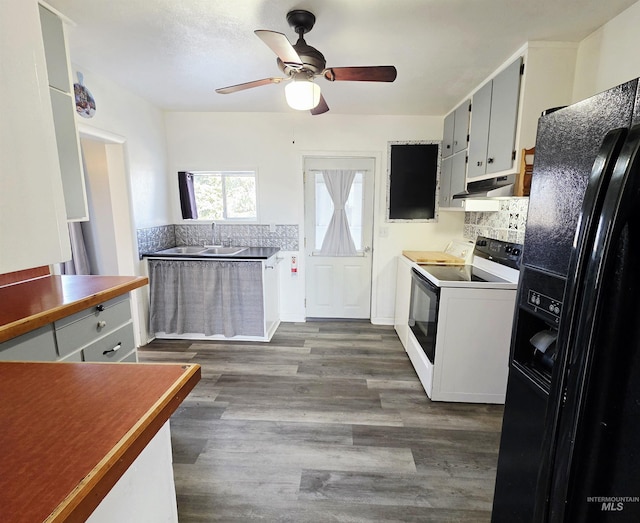 522 Ellis Ave, Winchester, ID 83555 - kitchen featuring black refrigerator with ice dispenser, white range with electric cooktop, under cabinet range hood, ceiling fan, and decorative backsplash