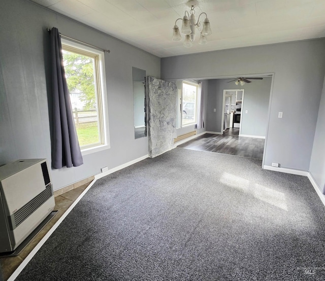 522 Ellis Ave, Winchester, ID 83555 - unfurnished living room featuring heating unit, a chandelier, carpet floors, and plenty of natural light
