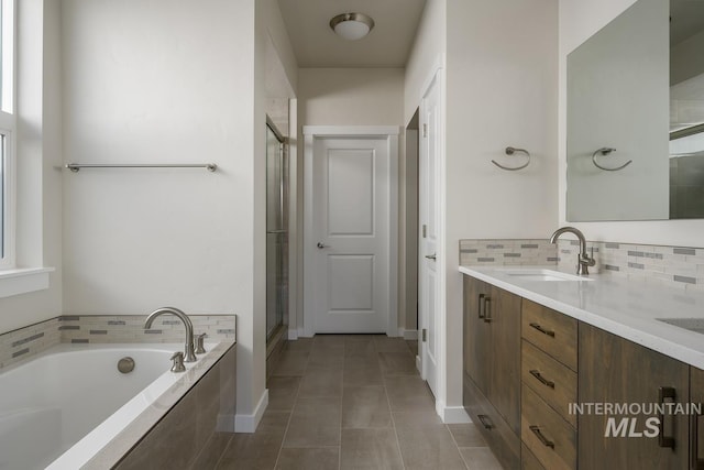 bathroom with vanity, shower with separate bathtub, tile patterned flooring, and decorative backsplash