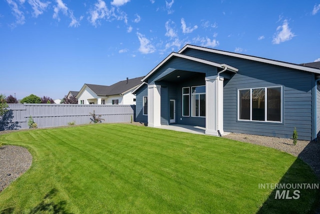 rear view of property with a lawn