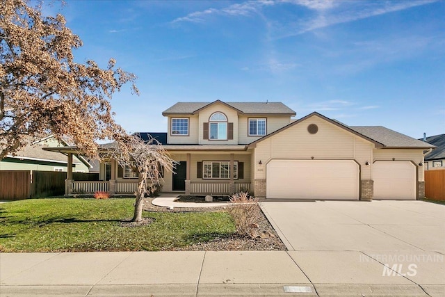 traditional-style home with concrete driveway, a porch, an attached garage, fence, and a front lawn