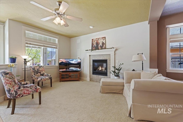 2260 N Eagle Creek Ln, Eagle, ID 83616 - carpeted living area featuring a textured ceiling, a tile fireplace, a ceiling fan, and baseboards