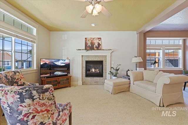 2260 N Eagle Creek Ln, Eagle, ID 83616 - living area with carpet, plenty of natural light, ceiling fan, a tile fireplace, and a textured ceiling
