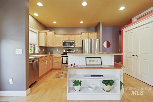 2260 N Eagle Creek Ln, Eagle, ID 83616 - kitchen featuring open shelves, appliances with stainless steel finishes, a sink, light brown cabinetry, and recessed lighting