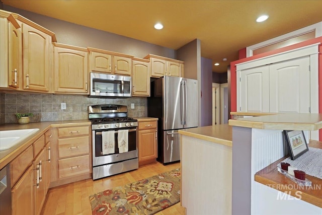 2260 N Eagle Creek Ln, Eagle, ID 83616 - kitchen with appliances with stainless steel finishes, light brown cabinets, and recessed lighting