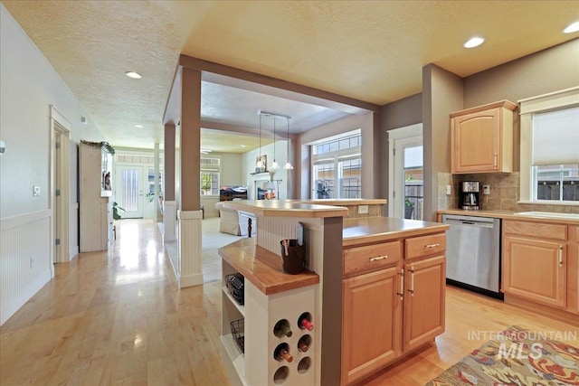 2260 N Eagle Creek Ln, Eagle, ID 83616 - kitchen with dishwasher, light brown cabinets, light wood-style flooring, light countertops, and wainscoting