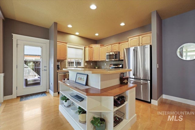 2260 N Eagle Creek Ln, Eagle, ID 83616 - kitchen featuring appliances with stainless steel finishes, open shelves, light brown cabinets, a center island, and decorative backsplash