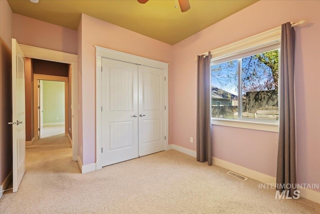 2260 N Eagle Creek Ln, Eagle, ID 83616 - unfurnished bedroom with carpet floors, a closet, baseboards, and a ceiling fan