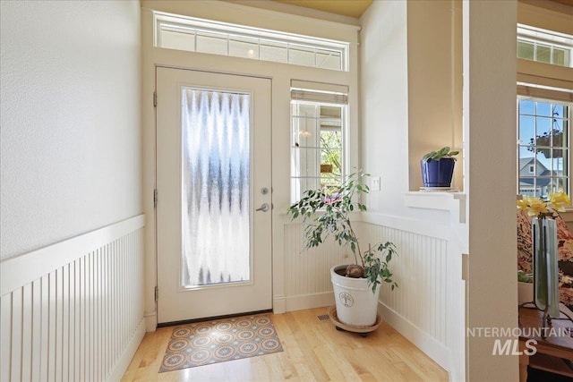 2260 N Eagle Creek Ln, Eagle, ID 83616 - doorway to outside featuring wood finished floors and wainscoting