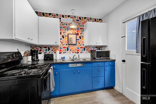 kitchen featuring dark countertops, black appliances, blue cabinetry, and white cabinets