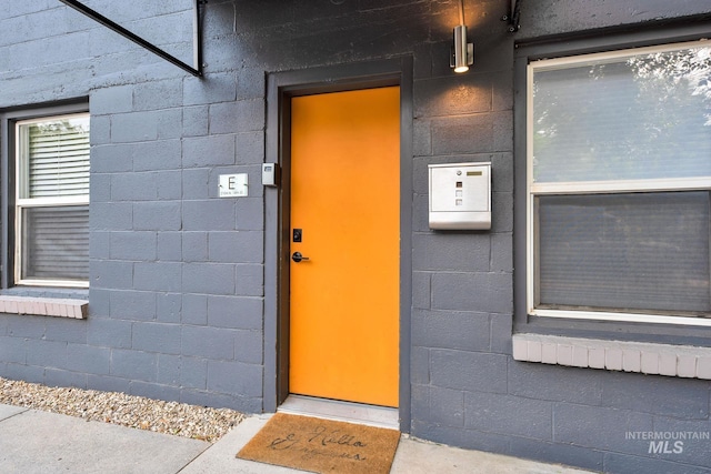 property entrance with concrete block siding