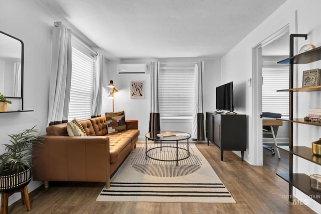 living area with dark wood finished floors and a wall mounted air conditioner