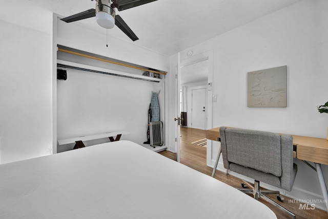 bedroom with a ceiling fan and wood finished floors