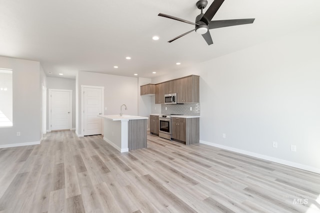 4435 N Magical Creek Ave, Meridian, ID 83646 - kitchen with stainless steel appliances, open floor plan, light countertops, and recessed lighting