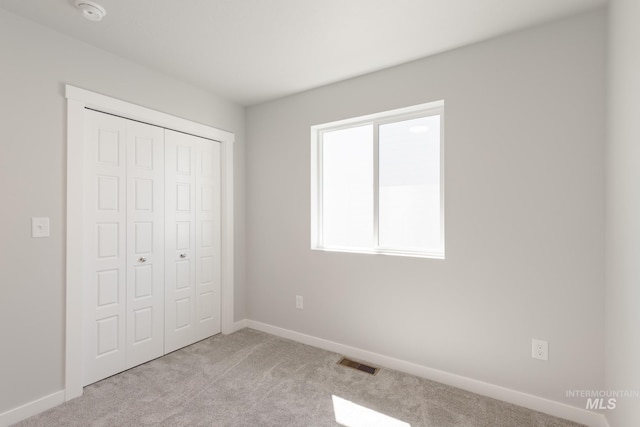 4435 N Magical Creek Ave, Meridian, ID 83646 - unfurnished bedroom with a closet, visible vents, baseboards, and light carpet
